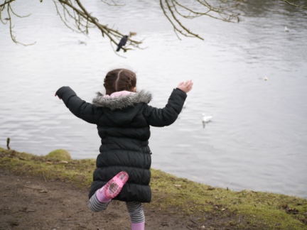 Rhiannon throwing bread for the jackdaws and seagulls