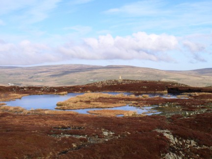 The tarn on the summit of Cronkley Fell looking to the trig point